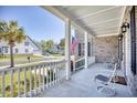 Relaxing front porch with white railings and chairs at 1206 East Isle Of Palms, Myrtle Beach, SC 29579