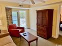 Bright living room with comfortable seating and a balcony view at 14290 Ocean Highway # 111, Pawleys Island, SC 29585
