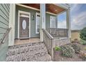 Inviting front porch with brick steps and rocking chairs, leading to a charming two-story home at 202 Palmetto Harbour Dr., North Myrtle Beach, NC 29582