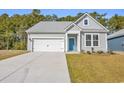 Newly built home with gray siding and teal door at 397 Sun Colony Blvd., Longs, SC 29568