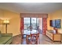 Dining area with ocean view, glass table, and four chairs at 6804 N Ocean Blvd. # 1409, Myrtle Beach, SC 29572