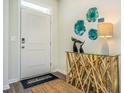 Bright entryway with a white door, console table, and wall art at 1155 Flintshire Dr., Myrtle Beach, SC 29579