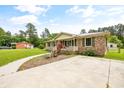 Brick ranch house with a large yard and driveway at 129 Meadowview Rd., Marion, SC 29571