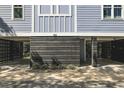 Covered parking under the house with dark wood siding at 104 Tidal Creek Dr., Murrells Inlet, SC 29576