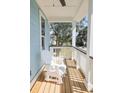 Relaxing front porch with rocking chair and view of street at 116 Tidal Creek Dr., Murrells Inlet, SC 29576