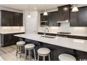 Open kitchen with large island and dark cabinets at 792 Indigo Bay Circle, Myrtle Beach, SC 29579