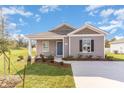 Gray house with front yard and driveway at 1910 Whispering Pine St., Ocean Isle Beach, NC 28469