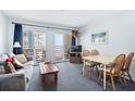 Living room with ocean view, sofa, table, and chairs at 920 N Waccamaw Dr. # 2106, Garden City Beach, SC 29576