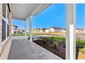 Covered porch with white columns overlooking the street at 555 Cypress Preserve Circle, Longs, SC 29568