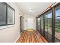 Bright sunroom with light wood floors, sliding doors, and a ceiling fan at 775 Plantation Dr. # 88, Little River, SC 29566