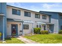 Front view of a light blue and white townhouse with a landscaped yard at 775 Plantation Dr. # 88, Little River, SC 29566