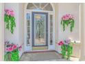 Elegant front entry with decorative glass door and hanging flower baskets at 5303 Pheasant Dr., North Myrtle Beach, SC 29582