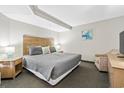 King-size bed, TV, and comfortable seating in this bedroom at 1501 S Ocean Blvd. # 646, Myrtle Beach, SC 29577
