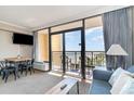 Living room with ocean view and balcony access at 6900 N Ocean Blvd. # 910, Myrtle Beach, SC 29572