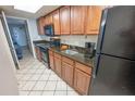 Kitchen with granite countertops, black appliances, and wood cabinets at 1501 S Ocean Blvd. # 1540, Myrtle Beach, SC 29577