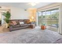 Bright living room with sliding glass door access to balcony at 8725 Chandler Dr. # F, Surfside Beach, SC 29575