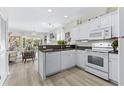 White kitchen with granite countertops and appliances at 242 Sun Colony Blvd. # 101, Longs, SC 29568