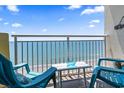 Balcony with ocean view, chairs, and small table at 2801 S Ocean Blvd. # 1838, North Myrtle Beach, SC 29582