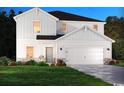 Two-story home, white siding, stone accents, landscaping at 7089 Watercress St, Myrtle Beach, SC 29579