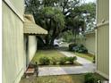 Side yard with a walkway, landscaping, and a partial view of the street at 150 Wedgefield Village Rd. # 24, Georgetown, SC 29440