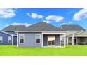 Home features a private covered patio and grassy backyard at 614 Castle Ct., Myrtle Beach, SC 29579