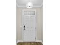 White front door with glass transom and updated hardware at 297 Broughton Dr., Myrtle Beach, SC 29579