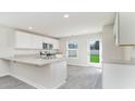 Island kitchen with stainless steel appliances and gray vinyl plank flooring at 1932 Whispering Pine St., Ocean Isle Beach, NC 28469