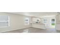 Bright and airy living room with gray vinyl plank flooring and access to a patio at 1932 Whispering Pine St., Ocean Isle Beach, NC 28469