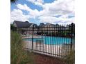 Community swimming pool with surrounding fence and lounge chairs at 173 Rocko Dr., Myrtle Beach, SC 29579