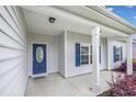 Covered front porch with blue door and white trim, inviting entryway at 268 Maple Oak Dr., Conway, SC 29526
