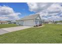 Detached garage with white door and gray siding, next to a well-maintained lawn at 268 Maple Oak Dr., Conway, SC 29526