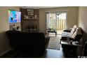 Living room with fireplace, TV, and patio doors at 1025 Carolina Rd. # M-3, Conway, SC 29526