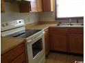 Kitchen with wood cabinets and white appliances at 1025 Carolina Rd. # M-3, Conway, SC 29526