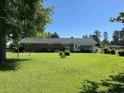 Brick ranch house with a large backyard and a screened porch at 4155 Pinewood Dr., Mullins, SC 29574