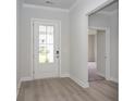 Bright entryway with white door, grey flooring and access to other rooms at 370 Rose Mallow Dr., Myrtle Beach, SC 29579