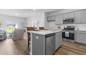 Modern kitchen with gray cabinets, white countertops, and kitchen island at 289 Sandridgebury Dr. # 65, Little River, SC 29566