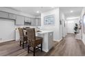 Modern kitchen with gray cabinets, white countertops, and kitchen island with seating at 289 Sandridgebury Dr. # 65, Little River, SC 29566
