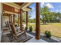 Relaxing front porch with rocking chairs and view of the yard at 2192 Eastwoods Dr., Conway, SC 29526