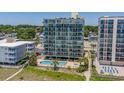 Aerial view of beachfront property with pool and surrounding buildings at 4301 S Ocean Blvd. # 1C, North Myrtle Beach, SC 29582