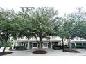 Building exterior showcasing a charming two-story building with a welcoming front porch at 4916 N N Market St. # 202, North Myrtle Beach, SC 29582