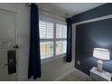 Bright entry with window, blue curtains, and a bedside lamp at 2000 N Ocean Blvd. # 1807, Myrtle Beach, SC 29577