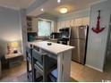 Kitchen with stainless steel appliances and a breakfast bar at 107 Toby Ct. # 103-A, North Myrtle Beach, SC 29582