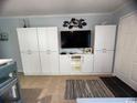 Living room with built-in shelving and a large flat-screen TV at 107 Toby Ct. # 103-A, North Myrtle Beach, SC 29582