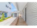 Wooden walkway and porch alongside the house with gray siding at 6001-5240 S Kings Hwy., Myrtle Beach, SC 29575
