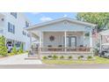 House exterior with front porch and landscaping at 6001-5240 S Kings Hwy., Myrtle Beach, SC 29575