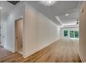 Light and airy hallway with wood-look floors and crown molding, leading to living areas at 205 Brush Ct., Little River, SC 29566