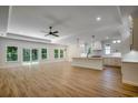 Open concept living space with hardwood floors, ceiling fan, and access to kitchen and backyard at 205 Brush Ct., Little River, SC 29566