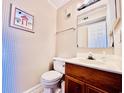 Small half bathroom with patterned wallpaper at 207 N Ocean Blvd. # 242, North Myrtle Beach, SC 29582