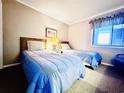 Bedroom with two twin beds and blue bedding at 207 N Ocean Blvd. # 242, North Myrtle Beach, SC 29582