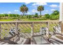 Private balcony overlooking a grassy area with mature trees at 1100 Possum Trot Rd. # C-101, North Myrtle Beach, SC 29582